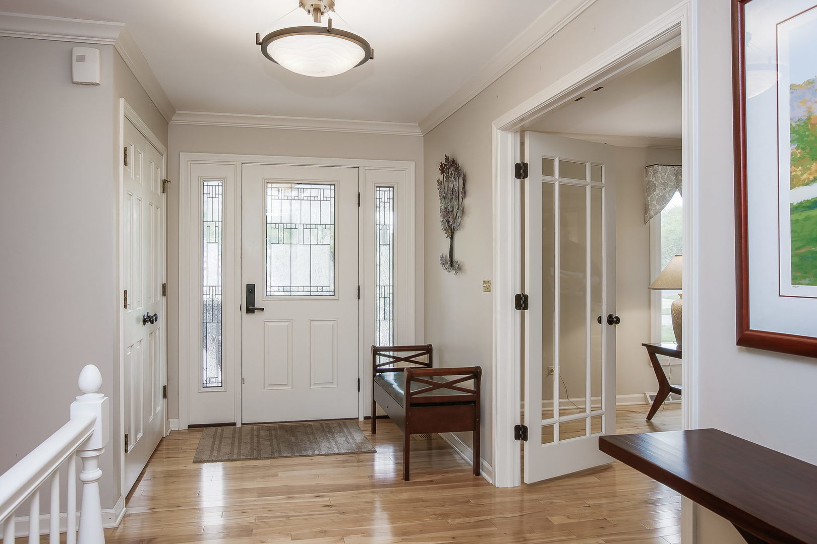 110 Stuarton Drive Wheaton, IL 60189 - Photo 11 of 30 a view of a hallway with wooden floor and a livingroom