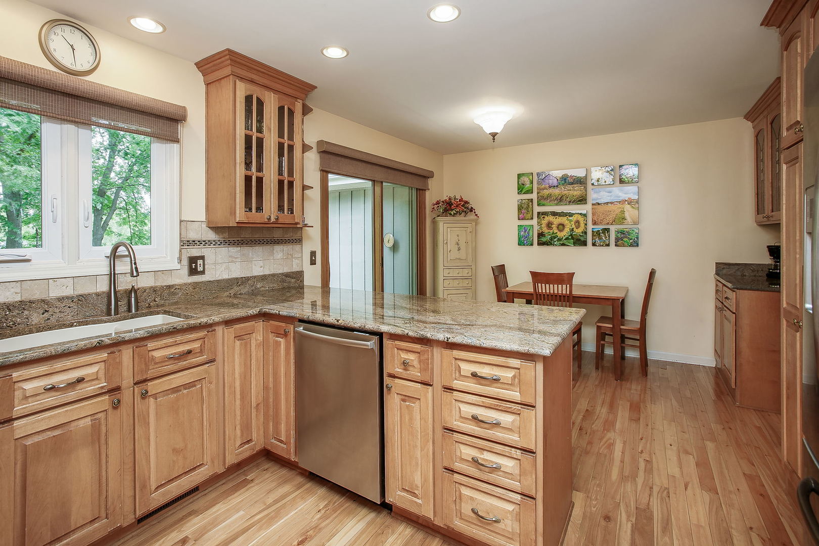 110 Stuarton Drive Wheaton, IL 60189 - Photo 19 of 30 a kitchen with a sink cabinets and wooden floor