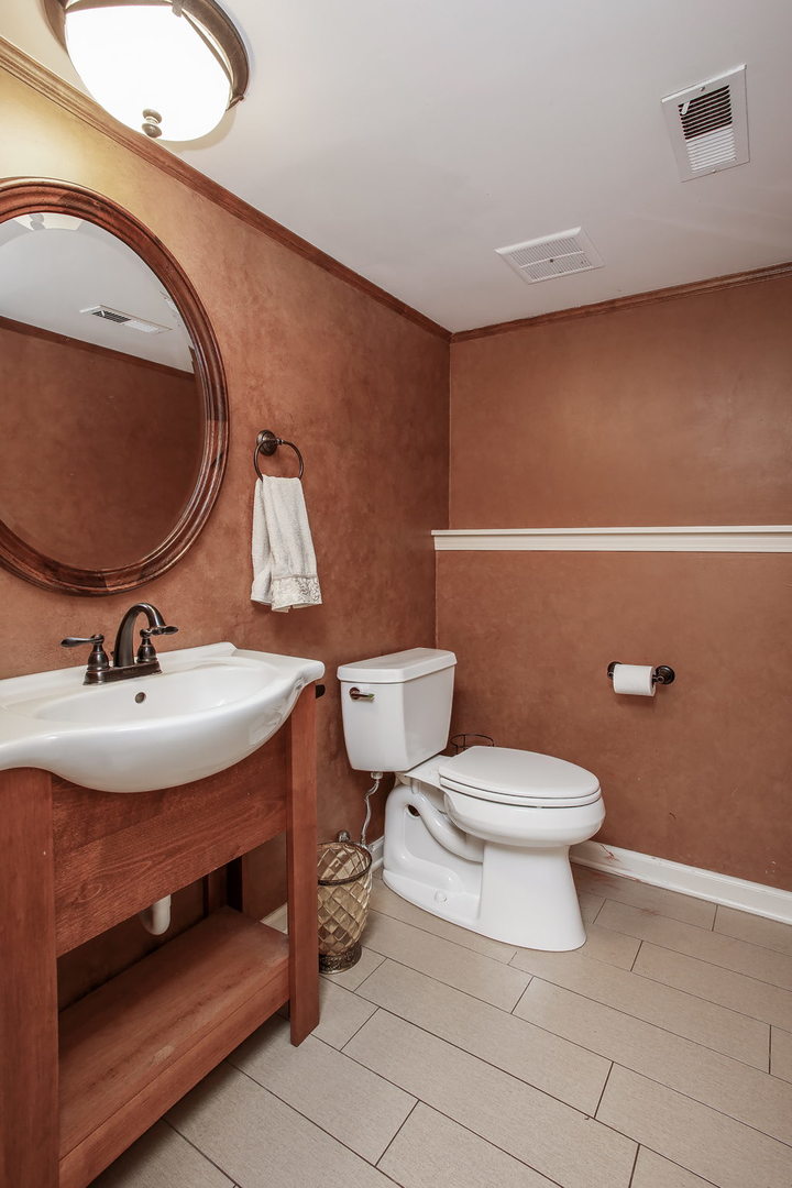 110 Stuarton Drive Wheaton, IL 60189 - Photo 25 of 30 a bathroom with a sink and a mirror