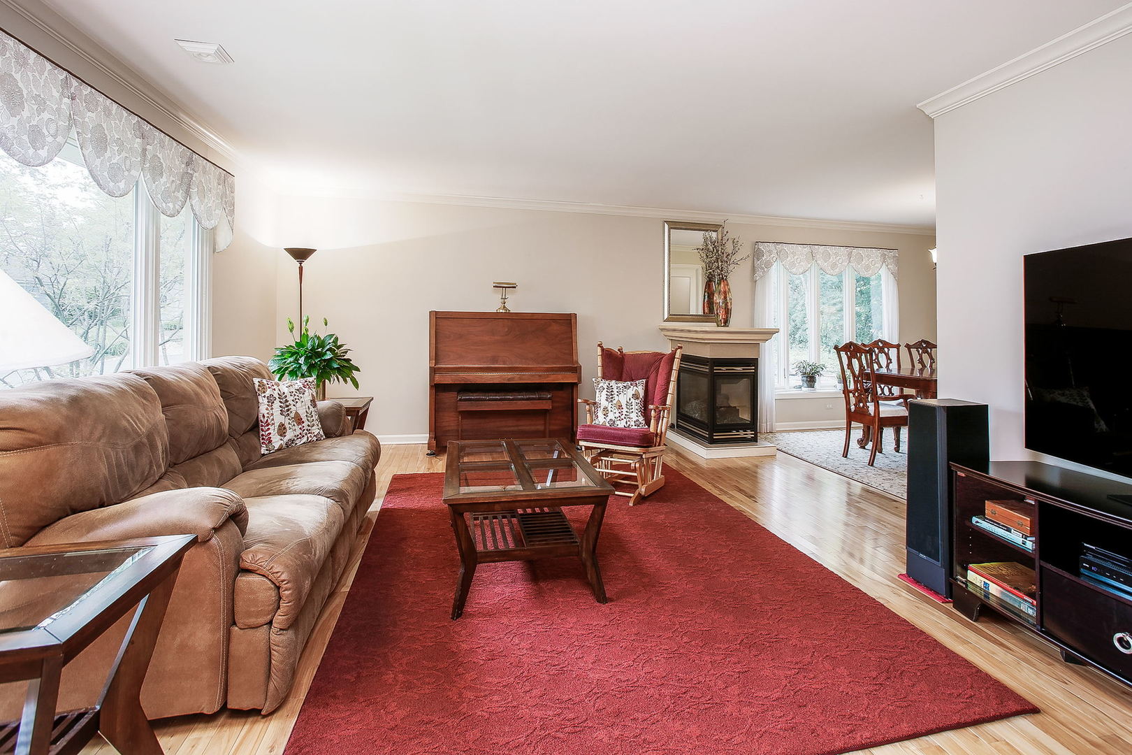 110 Stuarton Drive Wheaton, IL 60189 - Photo 9 of 30 a living room with furniture a flat screen tv and a fireplace