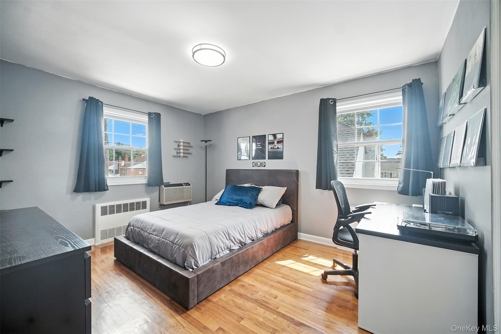 112 Casper Street Valley Stream, NY 11580 - Photo 16 of 26 a bedroom with a bed and wooden floor