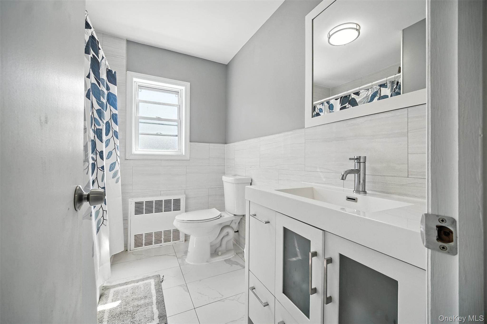 112 Casper Street Valley Stream, NY 11580 - Photo 17 of 26 a bathroom with a sink a toilet and a mirror
