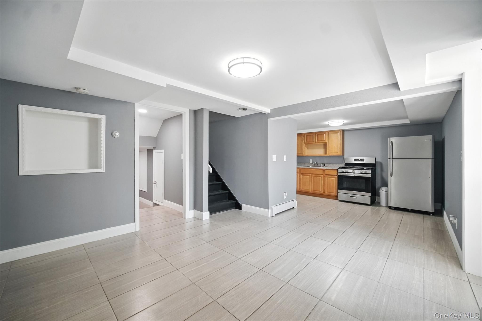 112 Casper Street Valley Stream, NY 11580 - Photo 18 of 26 a view of a kitchen with a sink and a refrigerator