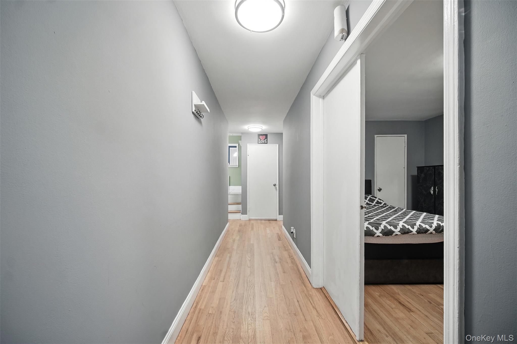 112 Casper Street Valley Stream, NY 11580 - Photo 3 of 26 a view of a hallway with wooden floor and staircase