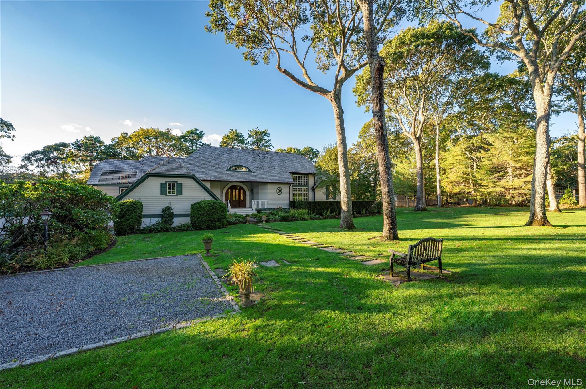 8 Fish Creek Lane Remsenburg, NY 11960 - Photo 10 of 34 a view of a big house with a big yard and large trees