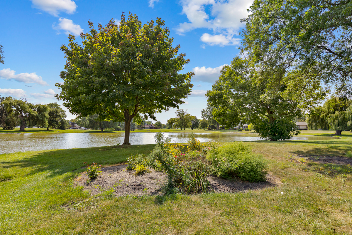 772 Leicester Road, Unit 772 Elk Grove Village, IL 60007 - Photo 17 of 21 a view of yard with swimming pool and green space