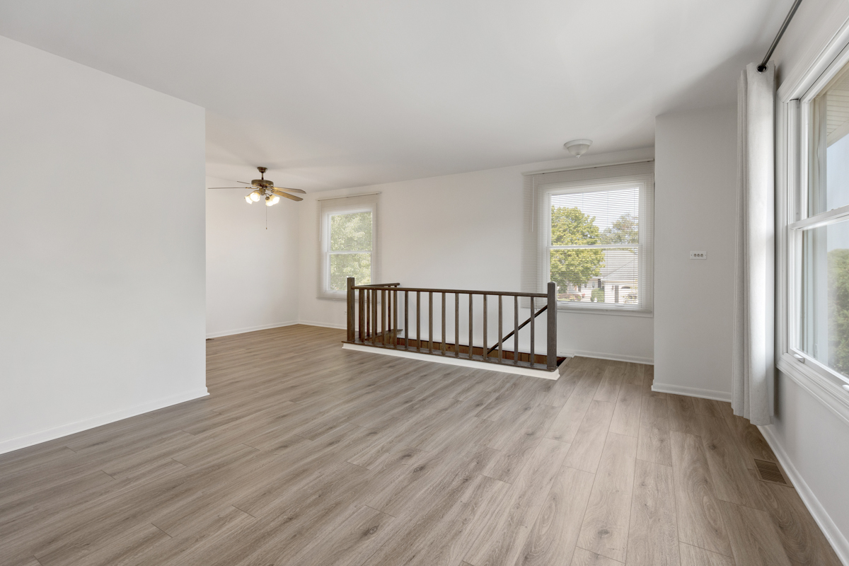 772 Leicester Road, Unit 772 Elk Grove Village, IL 60007 - Photo 4 of 21 wooden floor in an empty room with a window