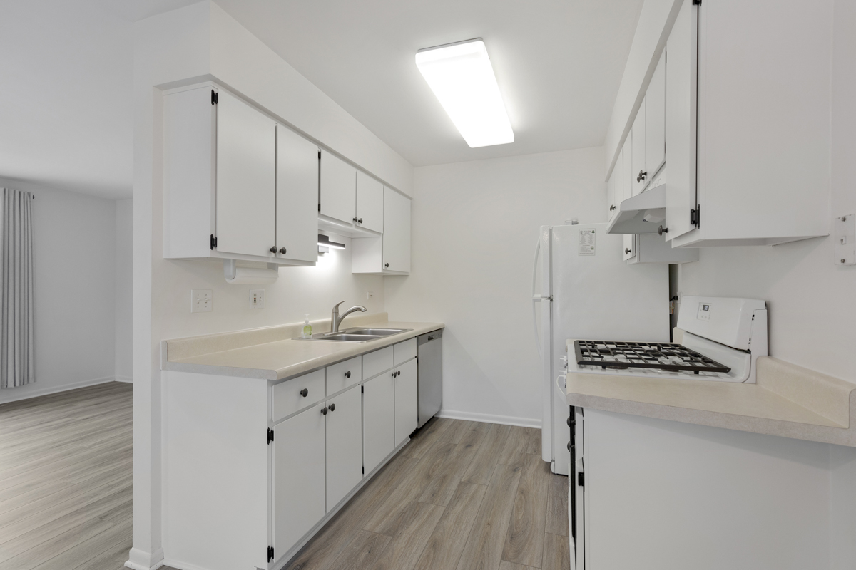 772 Leicester Road, Unit 772 Elk Grove Village, IL 60007 - Photo 7 of 21 a kitchen with stainless steel appliances a white stove top oven and cabinets