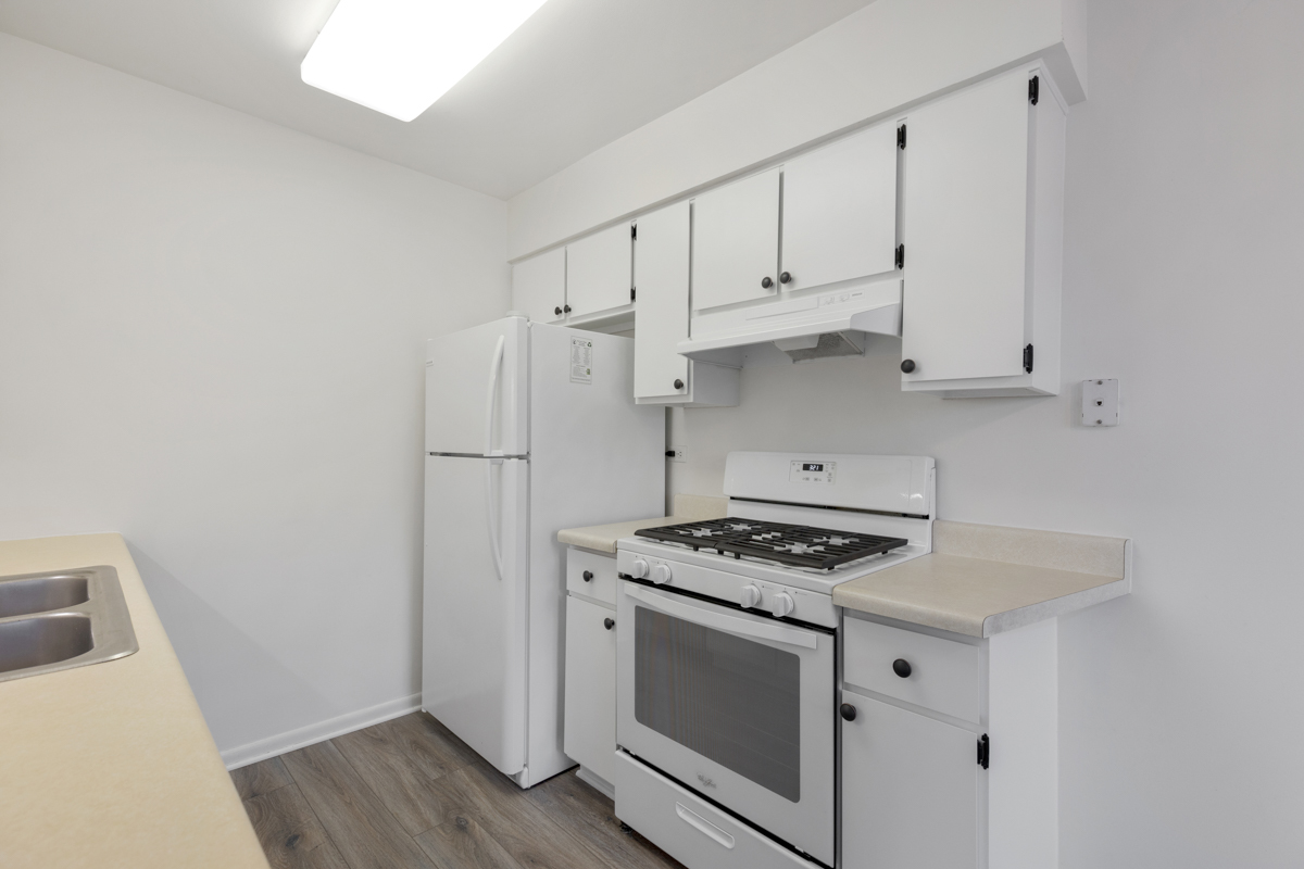 772 Leicester Road, Unit 772 Elk Grove Village, IL 60007 - Photo 9 of 21 a kitchen with white cabinets and white appliances