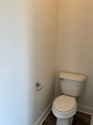 a view of a closet with wooden floor