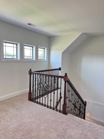 en empty room with window and chandelier fan