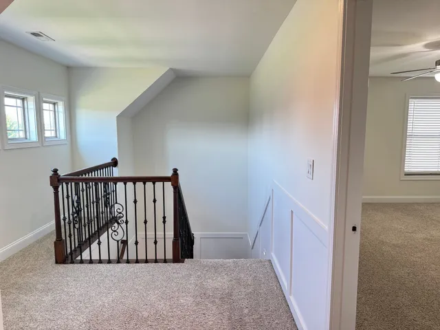 an empty room with closet and a ceiling fan