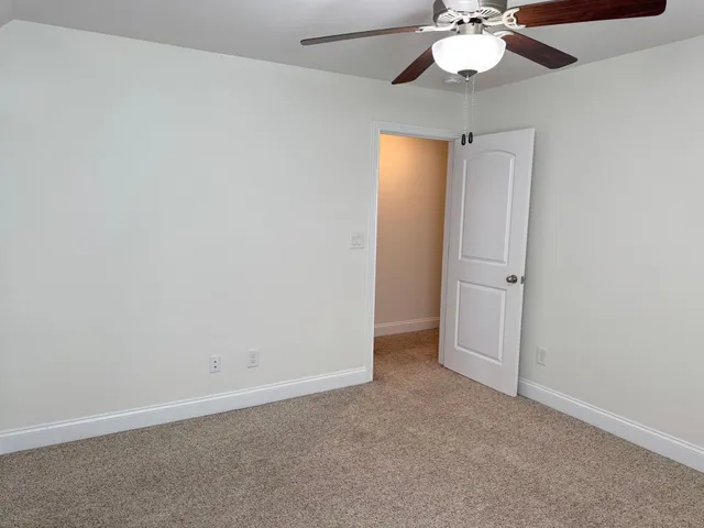 a white toilet sitting next to a bath tub