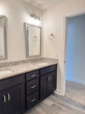 an empty room with closet and a chandelier fan