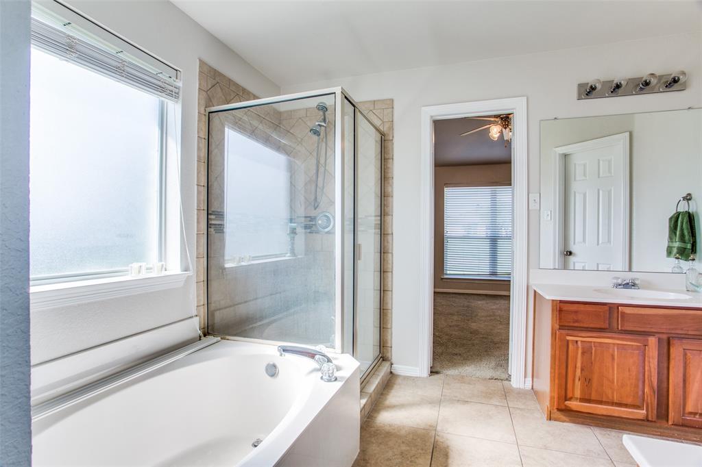 149 Shumard Drive Aledo, TX 76008 - Photo 10 of 12 a bathroom with a bathtub and a sink