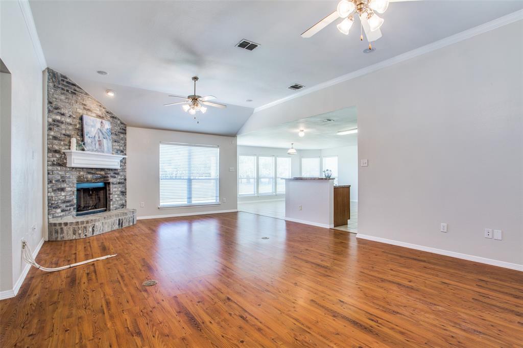 149 Shumard Drive Aledo, TX 76008 - Photo 2 of 12 a view of an empty room with wooden floor and a fireplace