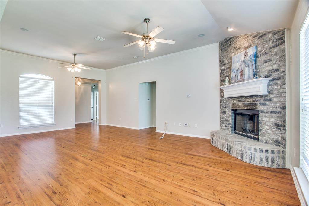 149 Shumard Drive Aledo, TX 76008 - Photo 3 of 12 a view of empty room with wooden floor and fireplace