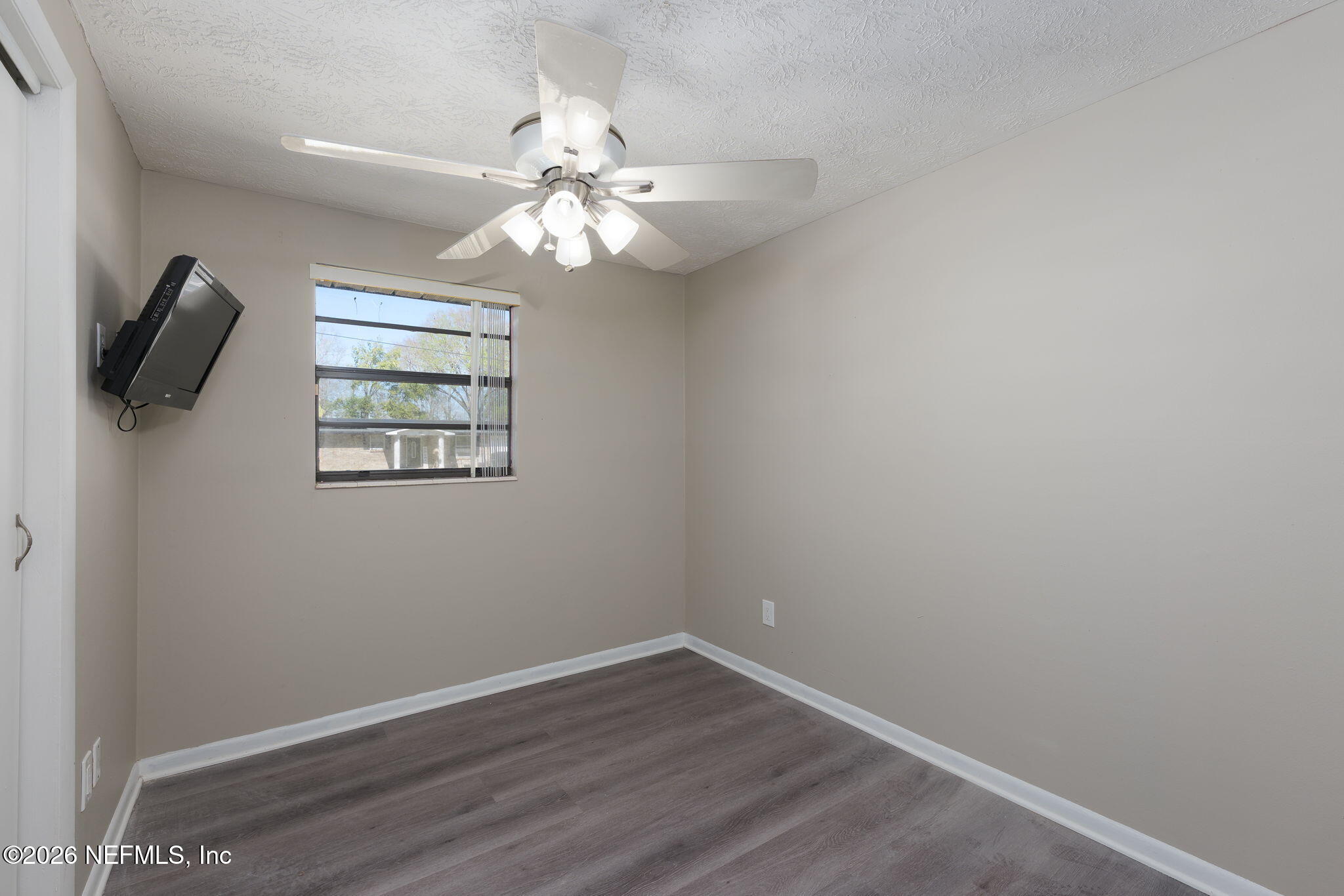 724 Miltondale Road Macclenny, FL 32063 - Photo 14 of 31 an empty room with wooden floor closet and fan