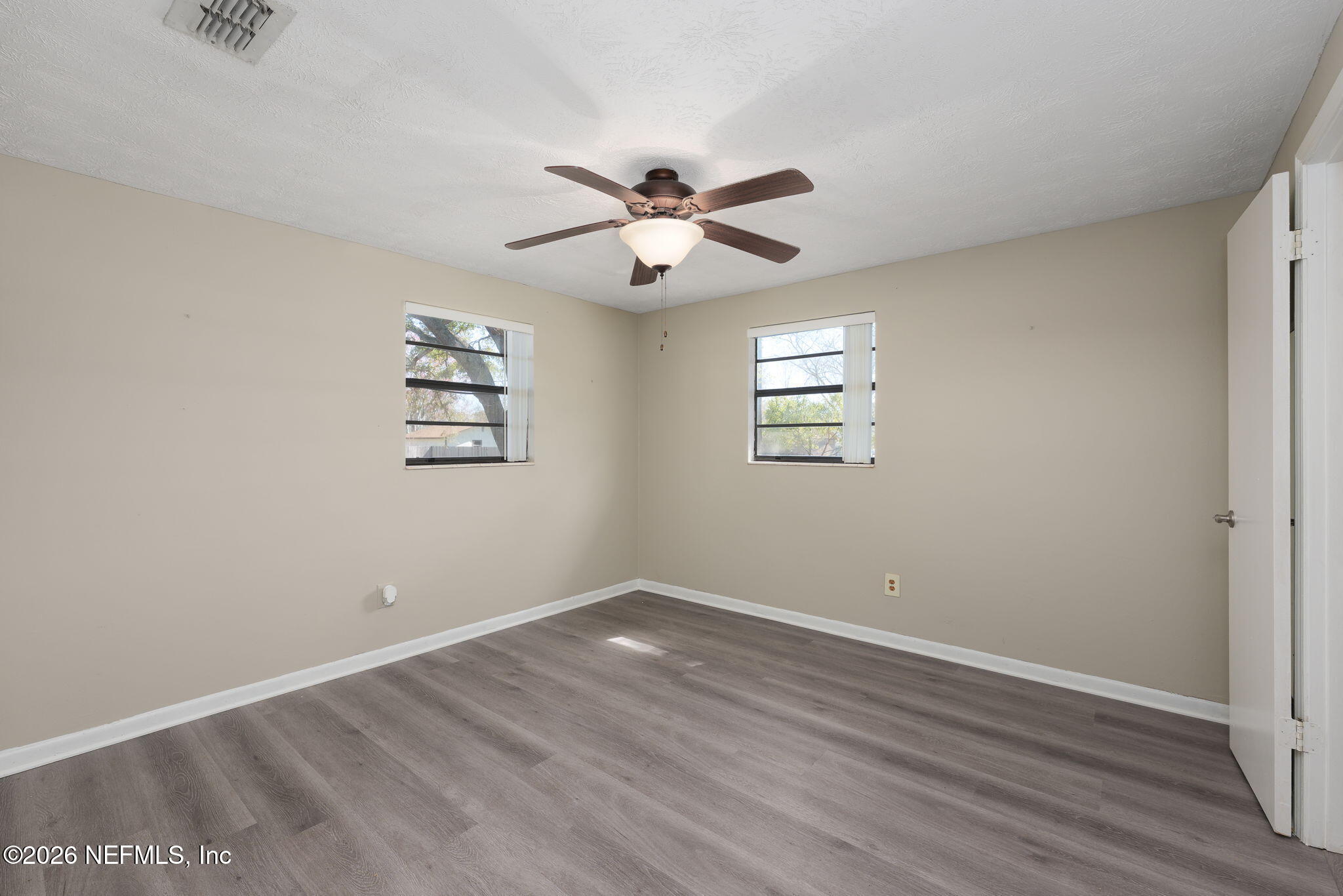 724 Miltondale Road Macclenny, FL 32063 - Photo 18 of 31 a view of a big room with wooden floor and a chandelier fan