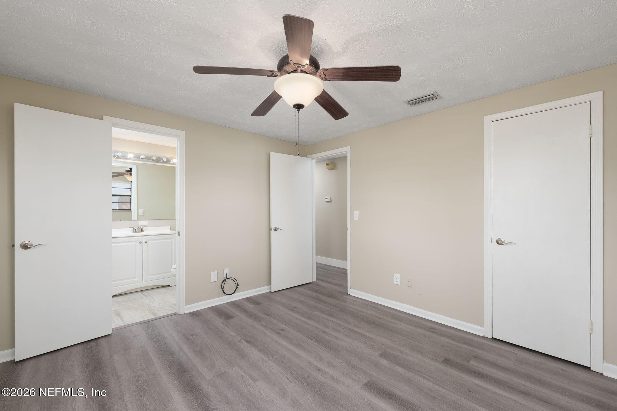 724 Miltondale Road Macclenny, FL 32063 - Photo 19 of 31 an empty room with wooden floor ceiling fan and windows