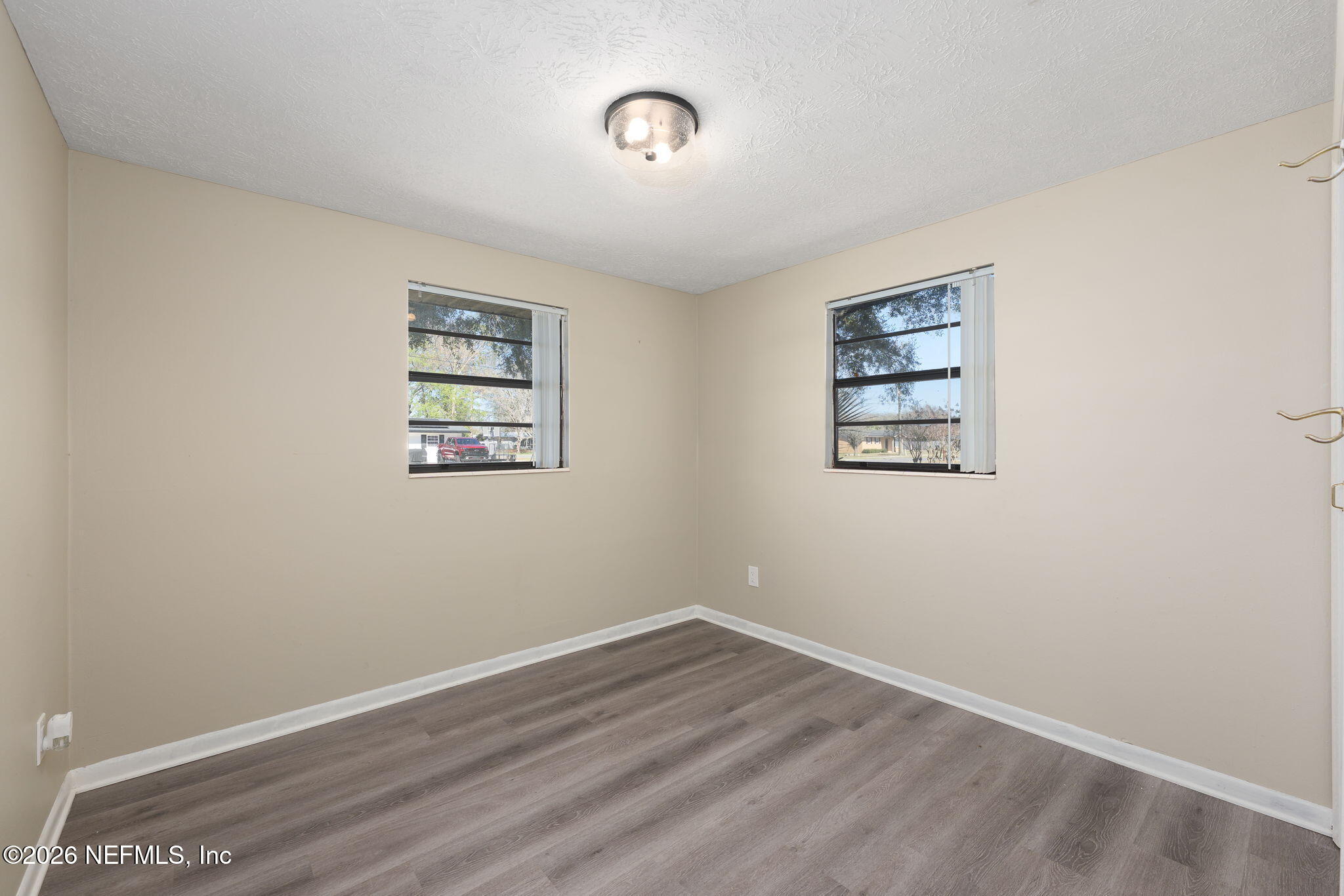 724 Miltondale Road Macclenny, FL 32063 - Photo 22 of 31 an empty room with a door and a window