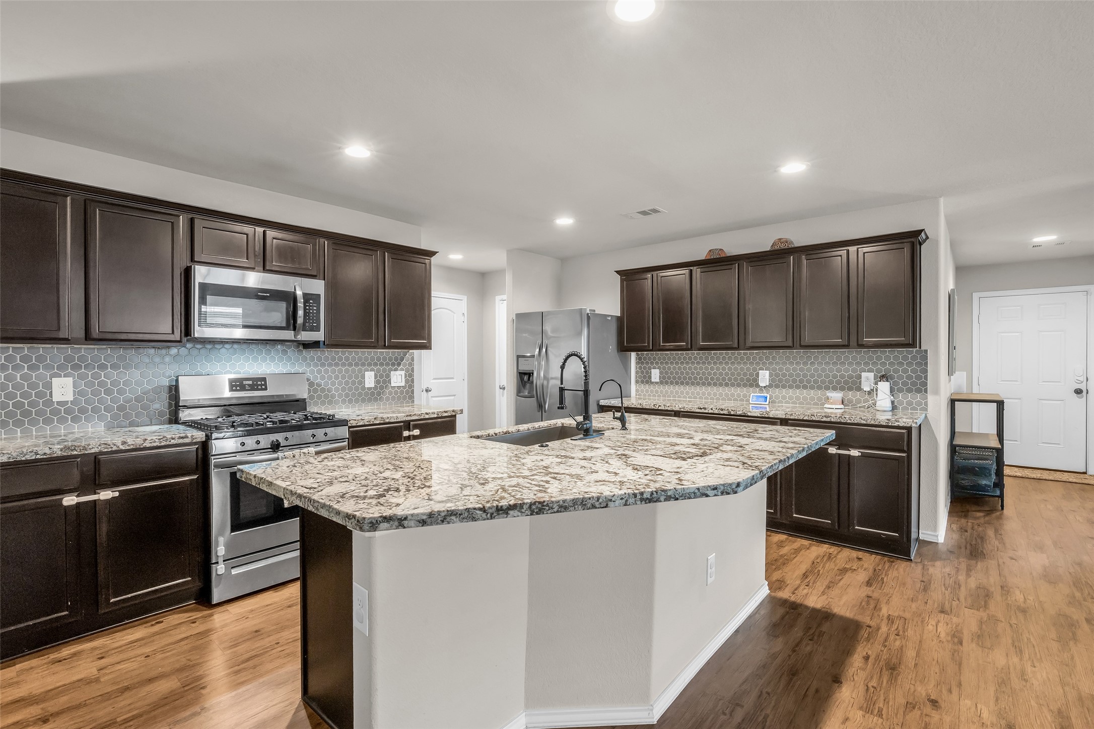 5635 Rainflower Terrace Lane Spring, TX 77389 - Photo 5 of 46 Rich granite & beautiful cabinets in this open style kitchen.