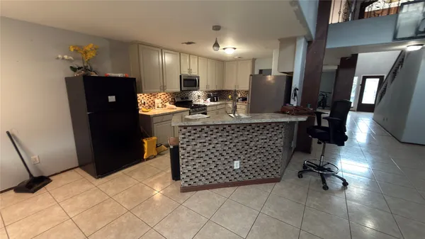 a kitchen with a sink a stove and refrigerator