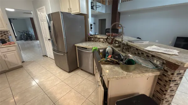 a kitchen with stainless steel appliances granite countertop a sink and a stove