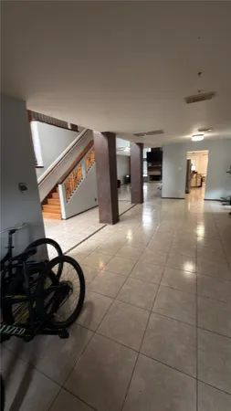 a lobby with furniture and a potted plant