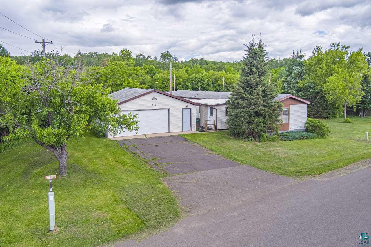 705 4th Street North Biwabik, MN 55708 - Photo 29 of 29 Single-story property with attached garage, paved driveway, and mature landscaping