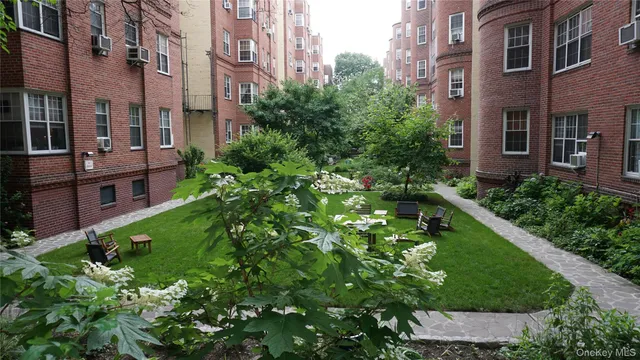 a backyard of a building with a garden and plants