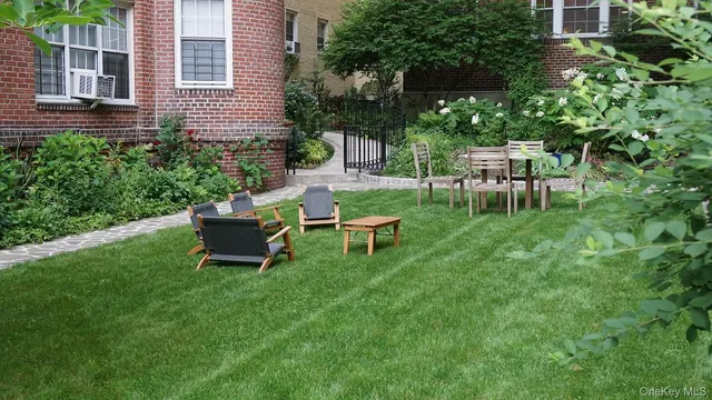 a view of a chair and table in backyard of the house