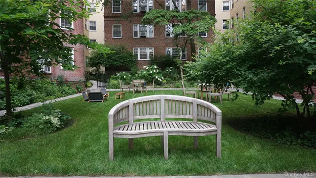 a view of a chair and table in the garden