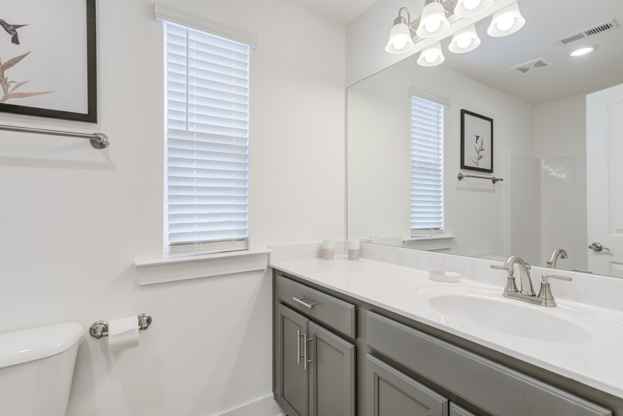 7030 Gracious Drive Franklin, TN 37064 - Photo 13 of 24 a bathroom with a sink a vanity and a large mirror