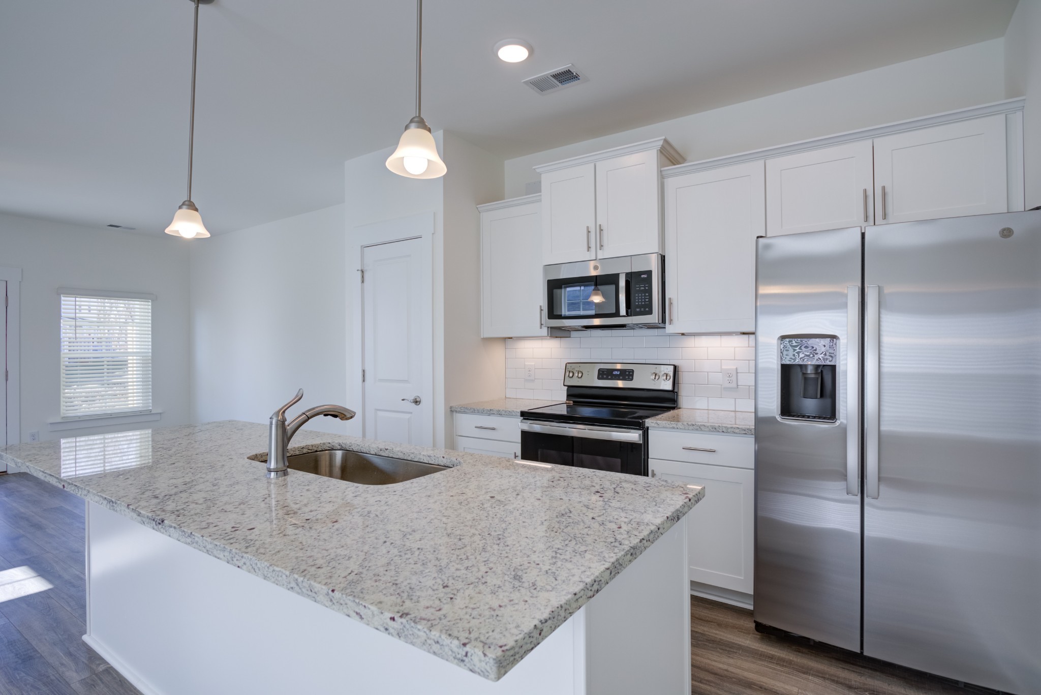 7030 Gracious Drive Franklin, TN 37064 - Photo 17 of 24 a kitchen with stainless steel appliances granite countertop a sink refrigerator and microwave