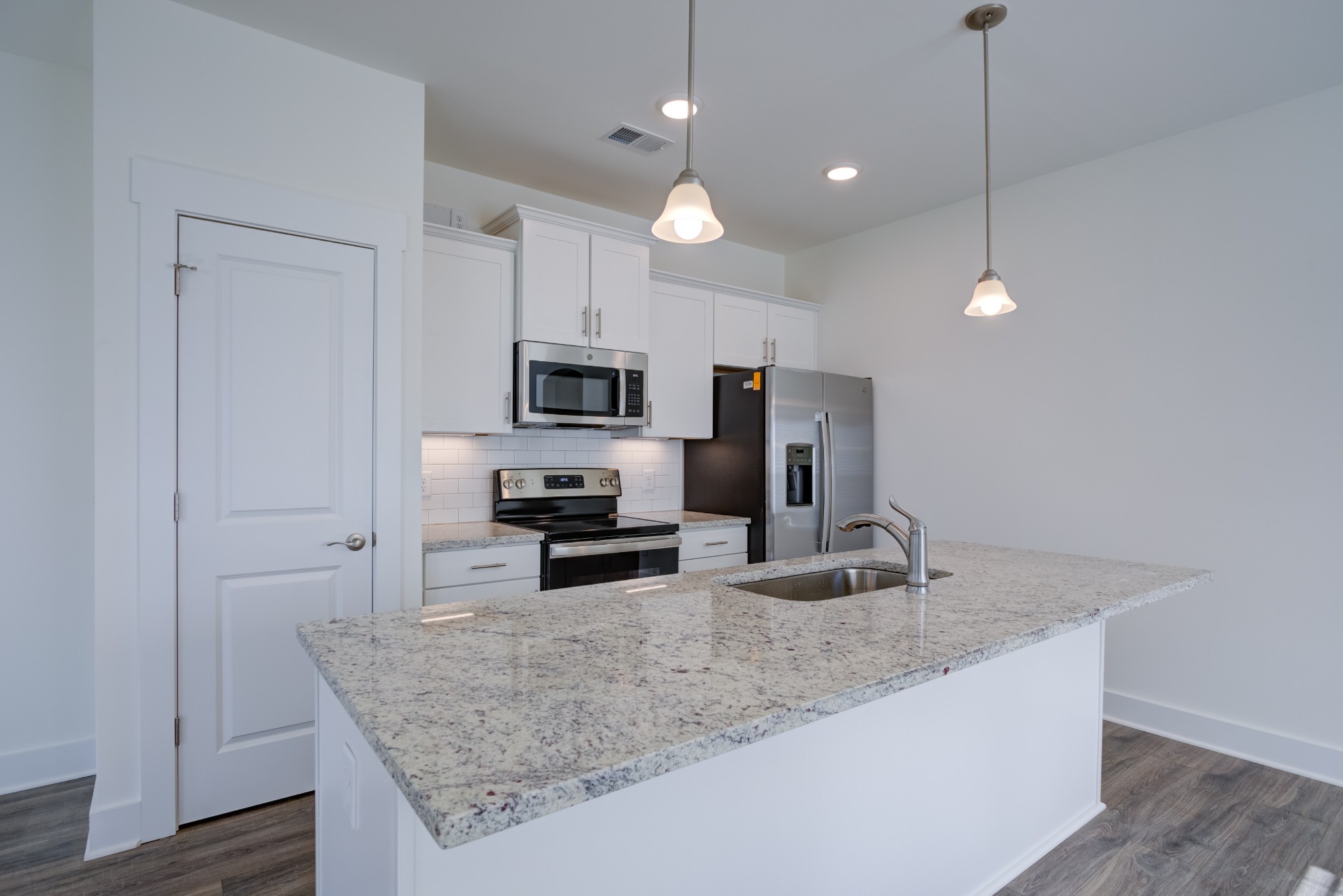 7030 Gracious Drive Franklin, TN 37064 - Photo 19 of 24 a kitchen with stainless steel appliances granite countertop a sink refrigerator and microwave