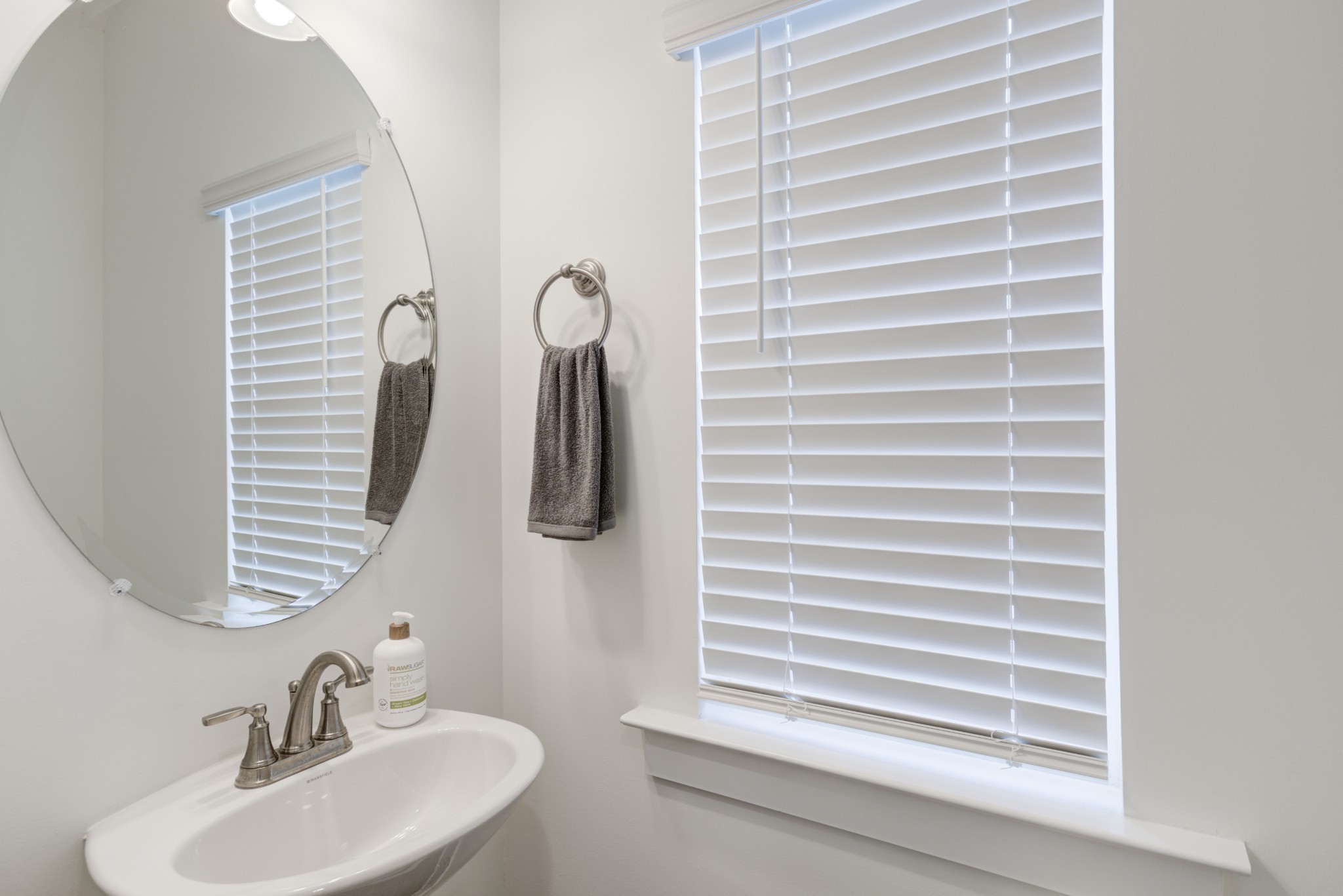 7030 Gracious Drive Franklin, TN 37064 - Photo 3 of 24 a bathroom with a sink a mirror and a window