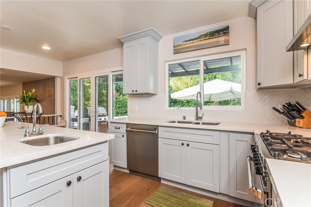 20153 Adele Drive Woodland Hills, CA 91364 - Photo 8 of 70 Kitchen - looking out onto back patio and pool