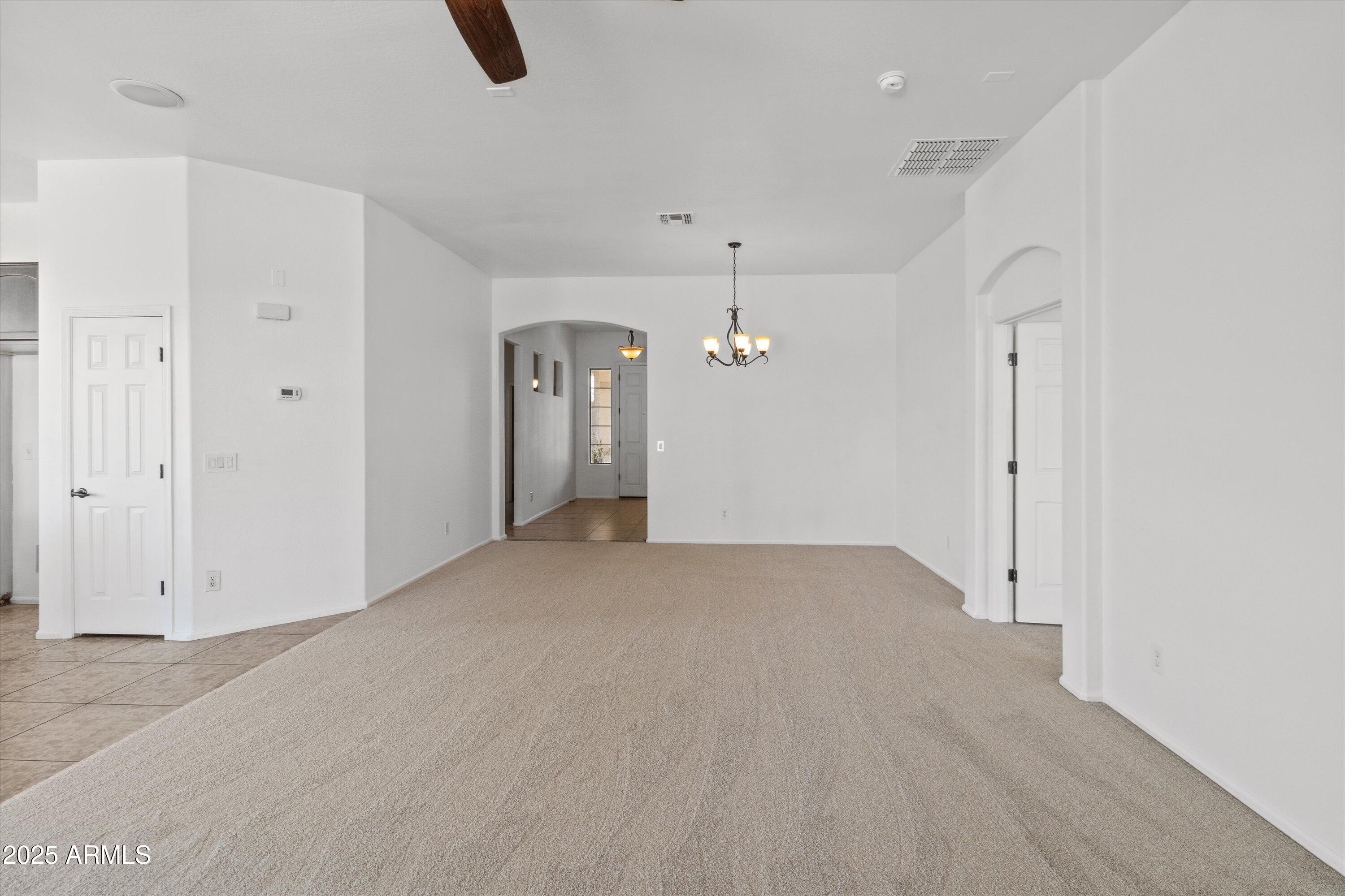 45076 West Rhea Road Maricopa, AZ 85139 - Photo 13 of 43 an empty room with ceiling fan and window