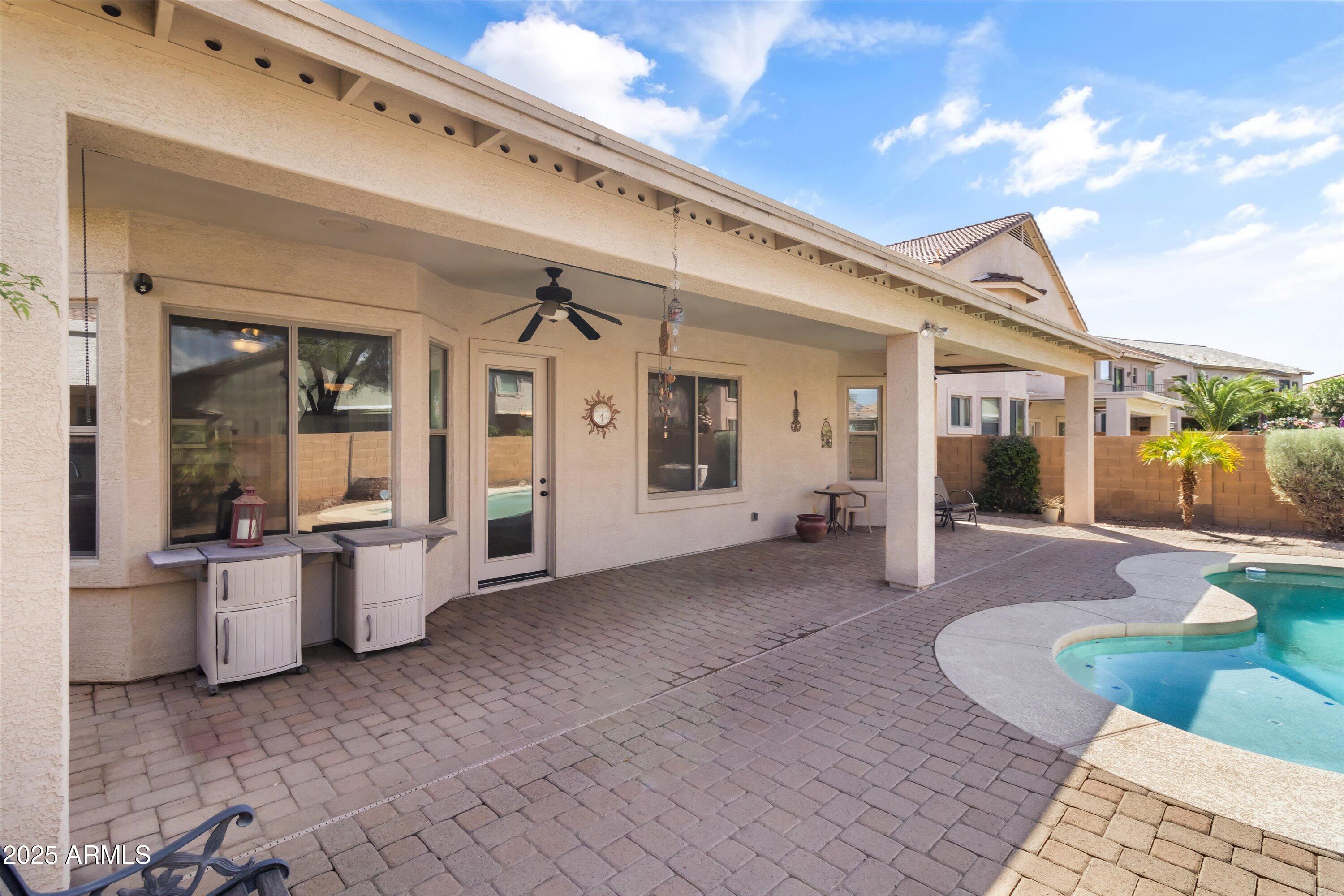 45076 West Rhea Road Maricopa, AZ 85139 - Photo 31 of 43 a view of a patio with couches chairs and potted plants