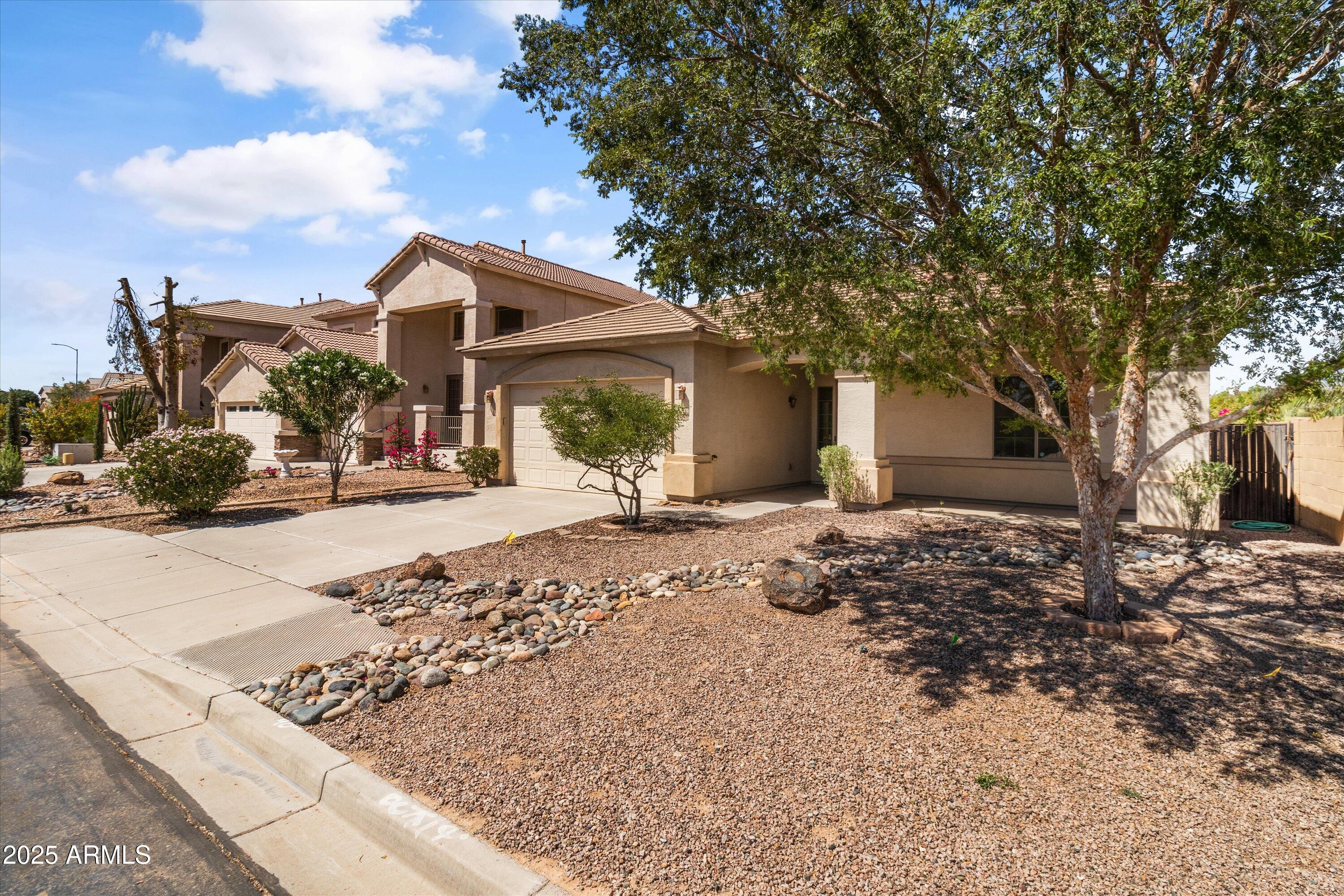 45076 West Rhea Road Maricopa, AZ 85139 - Photo 8 of 43 a front view of a house with a yard