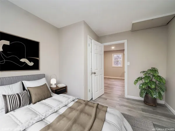 a bedroom with a bed and a potted plant