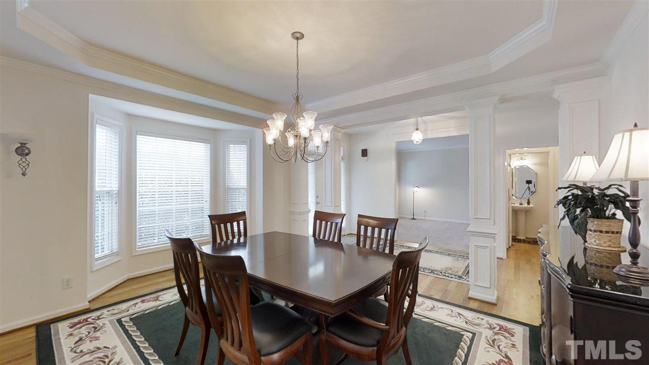 3233 Forestville Road Raleigh, NC 27616 - Photo 13 of 25 a view of a dining room with furniture window and wooden floor