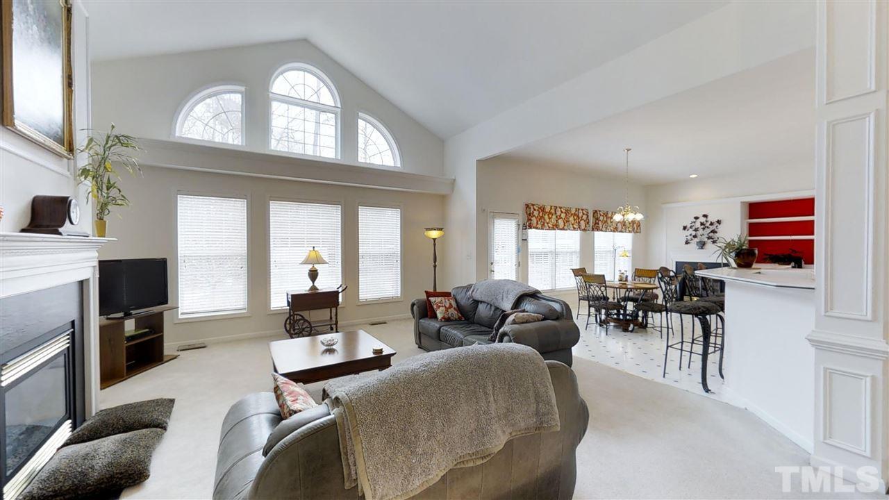 3233 Forestville Road Raleigh, NC 27616 - Photo 15 of 25 a living room with furniture large window and flat screen tv