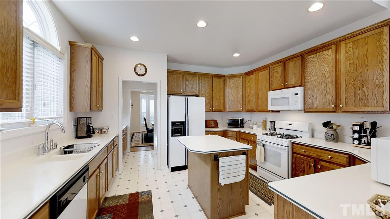 3233 Forestville Road Raleigh, NC 27616 - Photo 18 of 25 a kitchen with a sink stove and refrigerator