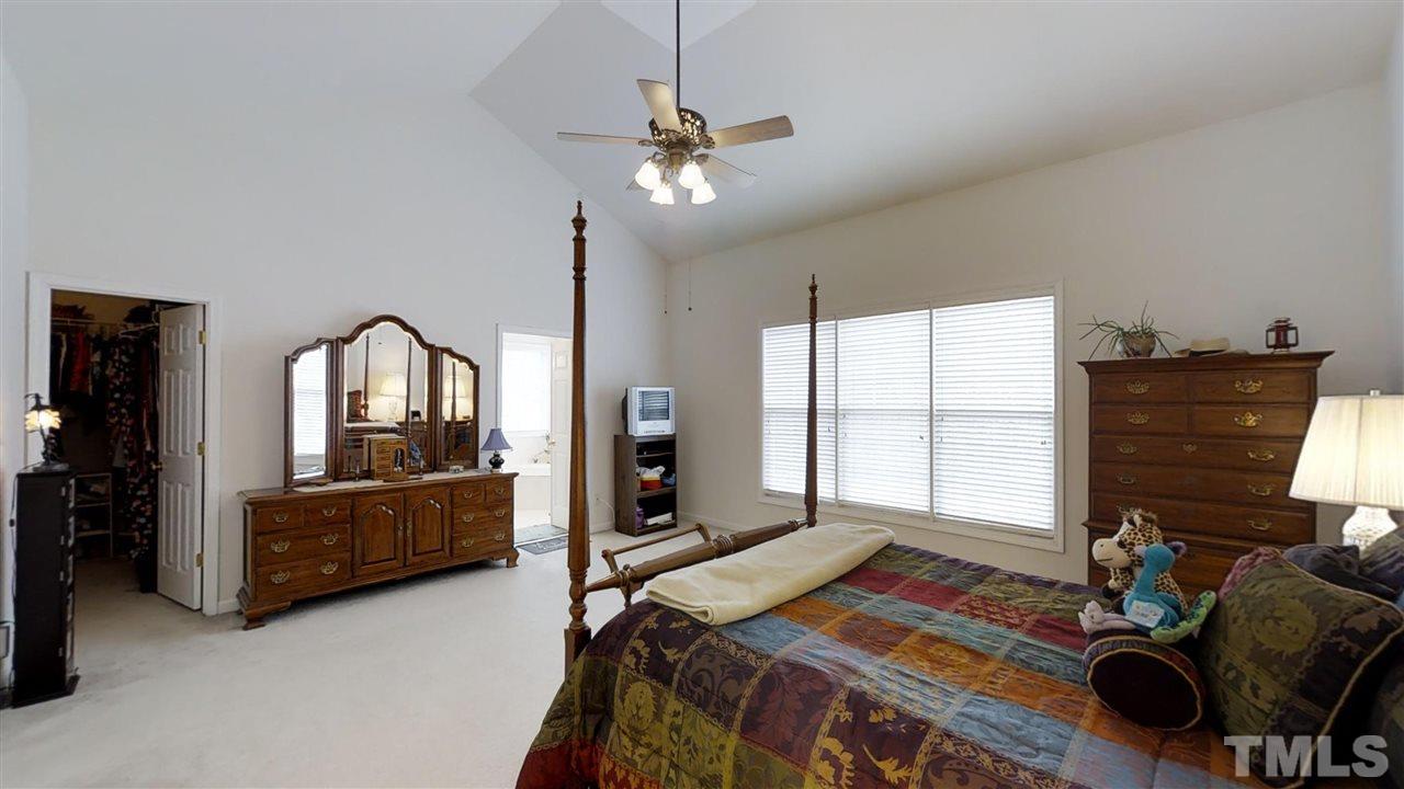 3233 Forestville Road Raleigh, NC 27616 - Photo 19 of 25 a bedroom with a bed and a dresser