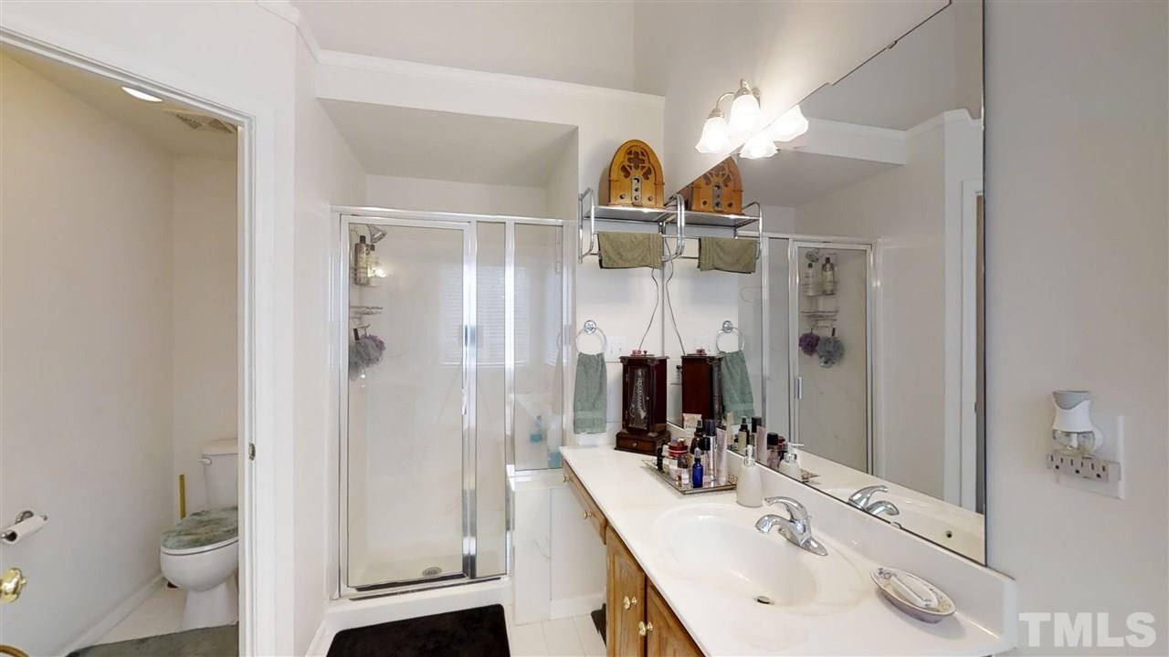3233 Forestville Road Raleigh, NC 27616 - Photo 21 of 25 a bathroom with a sink a toilet and a mirror