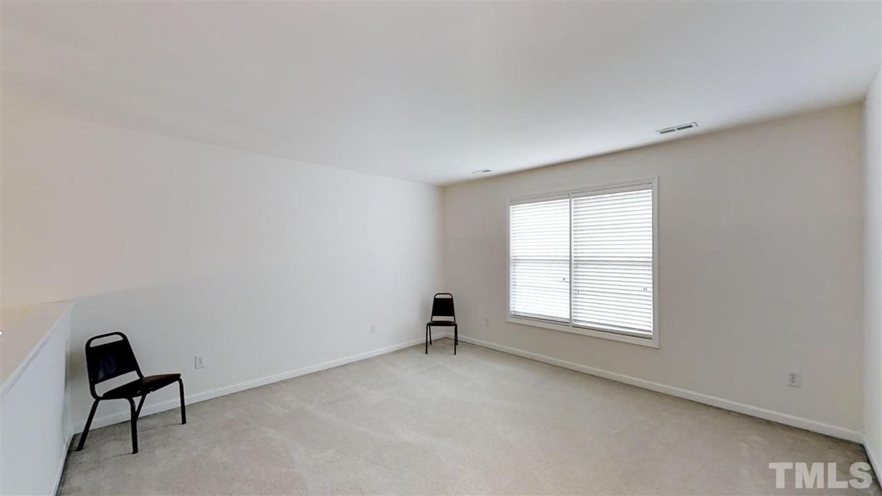 3233 Forestville Road Raleigh, NC 27616 - Photo 22 of 25 an empty room with windows and a dresser