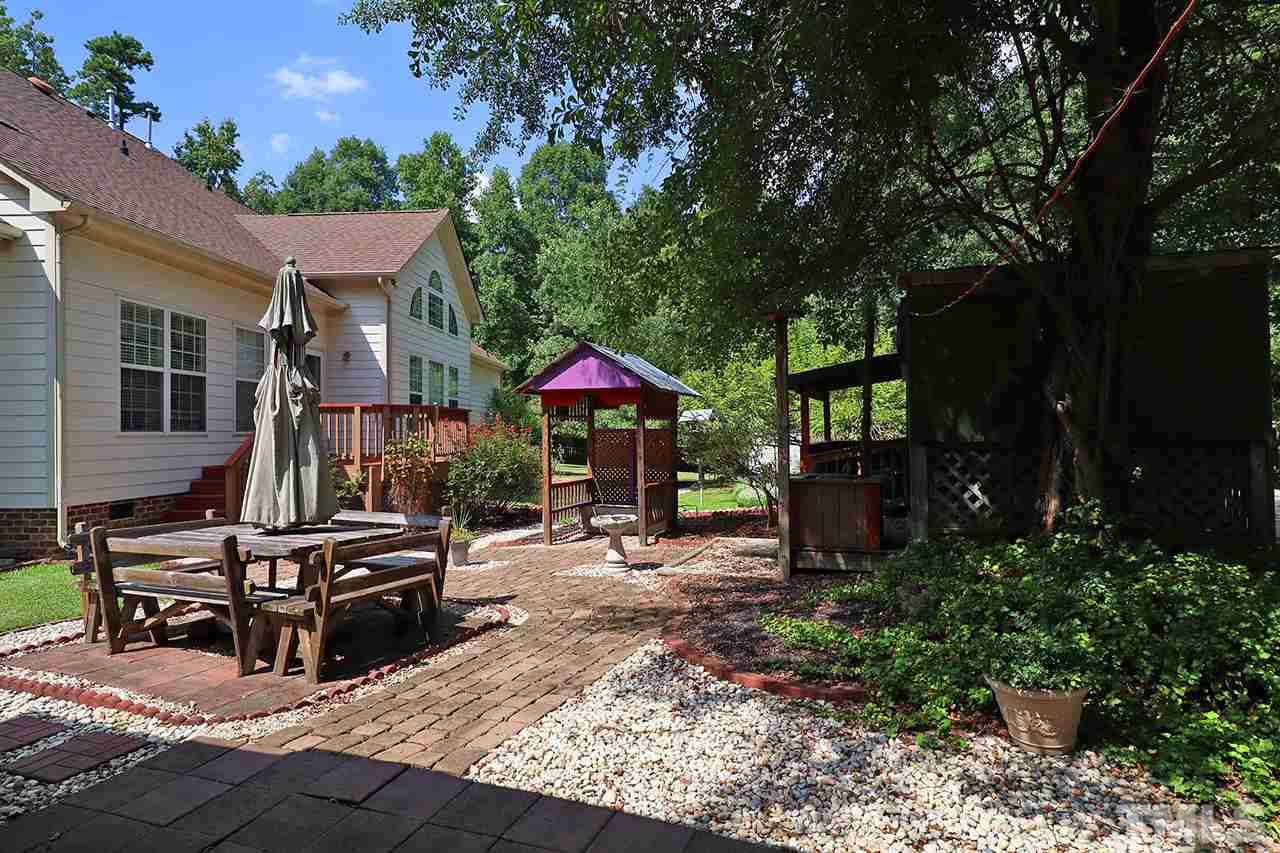 3233 Forestville Road Raleigh, NC 27616 - Photo 4 of 25 a view of a house with backyard and sitting area