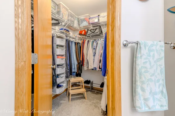 a view of walk in closet with clothes